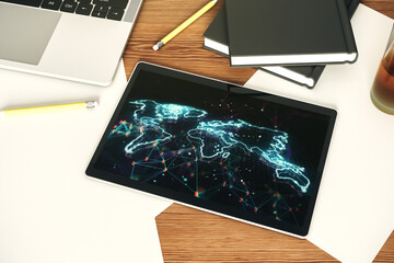 Modern digital tablet display with abstract creative world map, globalization concept. Top view. 3D Rendering