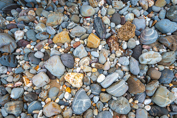 .amazing to see on the beach is full of round rocks instead of sand. .round rocks have beautiful color and various size. .rocks beach at the lighthouse landmark of Lanta island Krabi. stone background