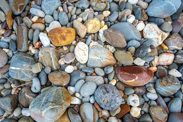 .amazing to see on the beach is full of round rocks instead of sand. .round rocks have beautiful color and various size. .rocks beach at the lighthouse landmark of Lanta island Krabi. stone background