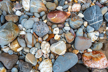 .amazing to see on the beach is full of round rocks instead of sand. .round rocks have beautiful color and various size. .rocks beach at the lighthouse landmark of Lanta island Krabi. stone background