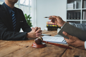 Lawyer or judge explaining details in documents and taking notes in a pocketbook according to legal and fair agreements Ethics and Integrity Hammer Litigation.