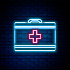 Glowing neon line First aid kit icon isolated on brick wall background. Medical box with cross. Medical equipment for emergency. Healthcare concept. Colorful outline concept. Vector