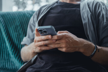 Handsome man call in smartphone, happy face, outdoor hipster portrait on the cafe, smile happy face, listen music on headphones, text, messenger, hipster, player,photo concept, laptop, coffee cup