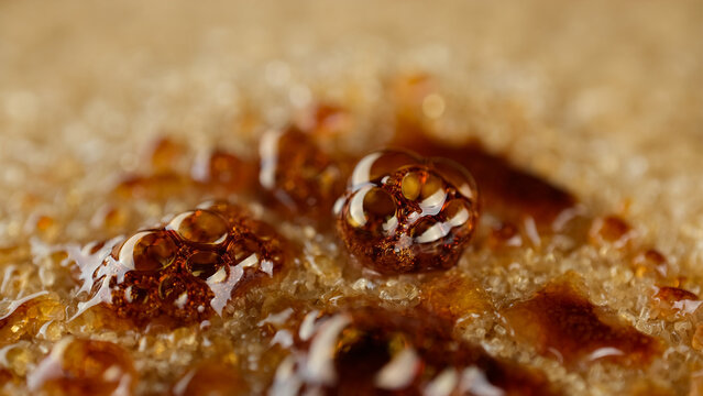 Caramelizing brown sugar using gas torch, close up