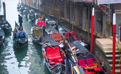 many gondolas moored under the Bridge of Sighs in Venice