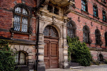 Facade of a old european historical building with vintage windows and doors 