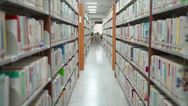 Bookshelves in modern university library with shelves full of books education background back to school concept