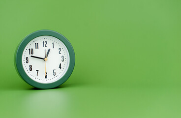 clock precious time alarm clock on green background concept of time working with time