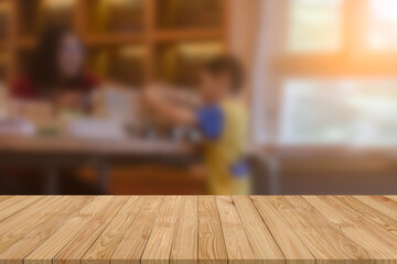 Empty perspective brown old plank wooden board mockup display as shelf or table with blurred mother and son joyful a snack box in their dining room with soft lighting from window background.