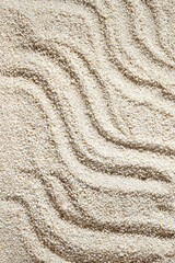 Waves ornament on neutral beige beach sand texture, aesthetic minimalist summer vacation...