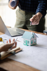 Fototapeta premium Architects and engineers are working together to edit the draft house plan that was designed after it was presented to the client and partially revised the design. Interior design and decoration ideas