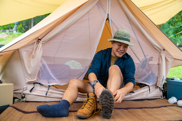 Happy Asian man enjoy outdoor adventure lifestyle camping in forest mountain on summer holiday...