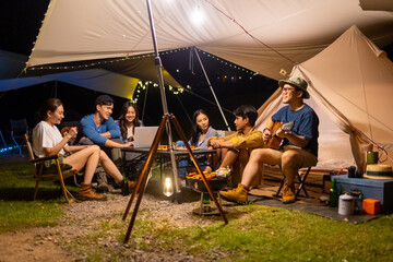 Group of Asian man and woman friends enjoy outdoor lifestyle celebrating holiday party having...