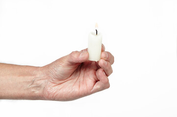 Men's hand holding a candle isolated white background. Man holding burning candle, closeup