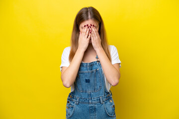 Young caucasian woman isolated on yellow background with tired and sick expression