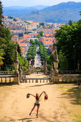 Happy traveler woman in Portugal- Lamego sanctuary and city panoramic view- Viseu disctric- Near Porto - obrazy, fototapety, plakaty