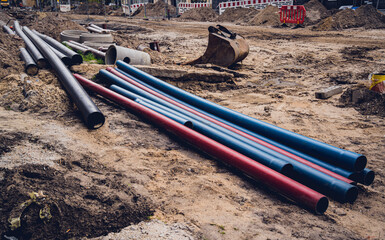 Big construction site with pipes and wires in the construction area. 