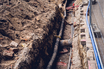 Big construction site with pipes and wires in the construction area. 