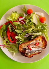 a salad with sardines on toast
