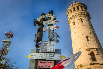 Signs next to lookout tower on the peak of Wielka Sowa Mountain in Owl Mountains Landscape Park, Poland © Fotokon