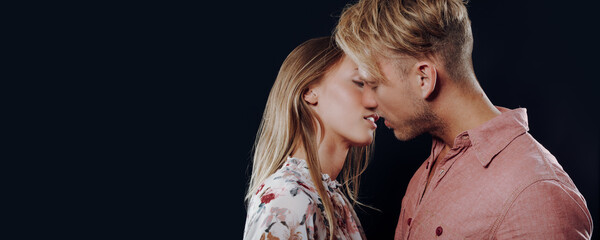  young blonde couple's love was evident as they locked lips in a passionate kiss, lost in the moment and warmth of each other while their affectionate gesture was beautiful display of  bond they share