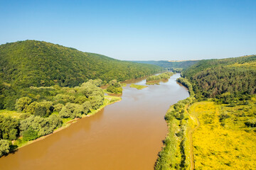 Gorgeous bird's eye view of a quiet river flowing through a hilly area. Dniester canyon national park, Ukraine, Europe.