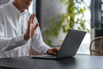 Man with laptop having video call
