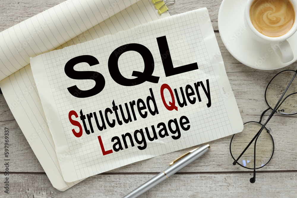 Wall mural sql language . large notepad with text near cup of coffee and glasses