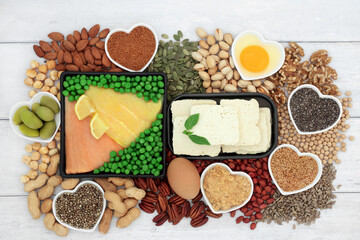 Fototapeta na wymiar Low cholesterol healthy heart food high in essential fatty acids unsaturated good fats. Seafood, dairy, vegetables, legumes, nuts, seeds. High in fibre, omega 3, protein antioxidants. 
