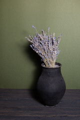 black jug with lavender flowers on a beautiful background