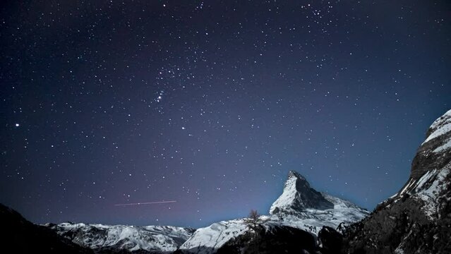 Night timelapse of the stars above matterhorn mountain in Zermatt Switzerland