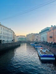 evening city river with ferries, bright sky after the sunset, white nights in Saint-petersburg