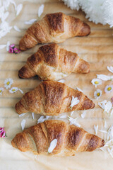 Freshly baked croissants with small flowers 