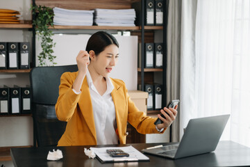 Business woman using tablet and laptop for doing math finance on an office desk, tax, report, accounting, statistics, and analytical research concept in office.