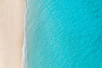 Summer seascape beautiful waves, blue sea water in sunny day. Top view from drone. Relax sea aerial view amazing tropical nature background. Tranquil bright sea waves splashing beach sand sunset light - obrazy, fototapety, plakaty