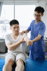 Patient at the physiotherapy doing physical exercises with therapist.