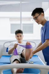 Patient at the physiotherapy doing physical exercises with therapist.