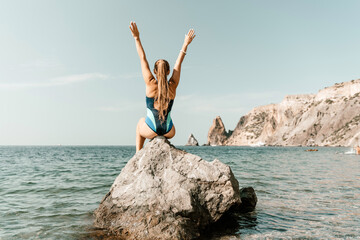 Woman beach vacation photo. A happy tourist in a blue bikini enjoying the scenic view of the sea...