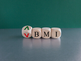 BMI big mac index symbol. Concept words BMI big mac index on wooden cubes. Beautiful green background. Business and BMI big mac index concept. Copy space.