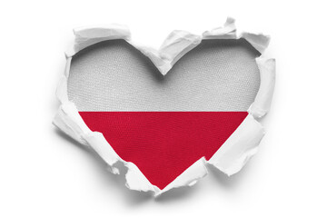 Naklejka na ściany i meble Heart shaped hole torn through paper, showing satin texture of flag of Poland, cut out