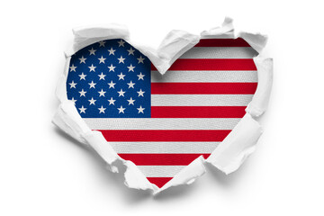 Heart shaped hole torn through paper, showing satin texture of flag of USA, cut out