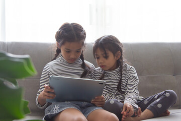 Education, elementary school, learning, technology and people concept - group of school kids with tablet pc computer having fun