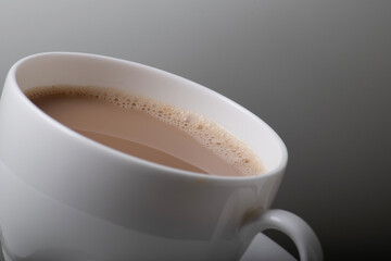 Closeup of milk tea in white porcelain cup