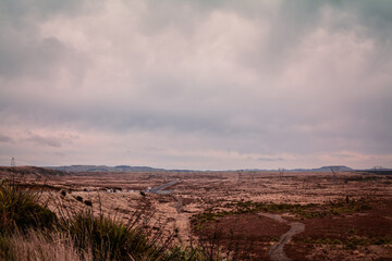 Retro style photo of a Volcanic Loop Hwy winding through vast and empty land. Desert Road, Central Plateau, New Zealand