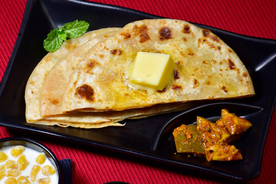 Closeup of aloo paratha with mango pickle indian breakfast