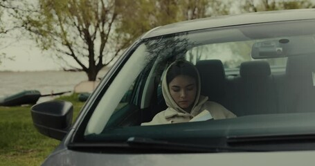 Woman reading a book sitting in a car at the nature Generative AI