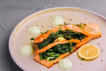 Pieces of fried salmon with dill and lemon