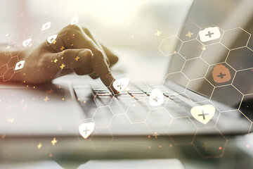 Creative abstract medical hologram and hands typing on computer keyboard on background, online medical consulting concept. Multiexposure