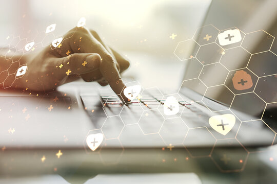 Creative abstract medical hologram and hands typing on computer keyboard on background, online medical consulting concept. Multiexposure