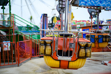 Daytime British colorful carnival fair amusement park rides